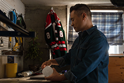 A man putting an eero device in his garage.
